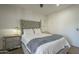 Main bedroom with ceiling fan, natural light, and painted concrete floor at 2719 N Greenfield Rd, Phoenix, AZ 85006