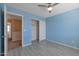 Comfortable bedroom showcasing light blue walls, and a closet for efficient storage at 3023 W Quail Ave, Phoenix, AZ 85027