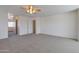 An expansive carpeted bedroom features neutral walls, a ceiling fan, and access to the bathroom and walk-in closet at 3023 W Quail Ave, Phoenix, AZ 85027