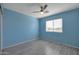 Bright bedroom with wood flooring, a ceiling fan, and natural light through a large window at 3023 W Quail Ave, Phoenix, AZ 85027