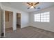 Cozy bedroom features an en-suite closet, a ceiling fan and ample natural light at 3023 W Quail Ave, Phoenix, AZ 85027