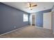 Serene bedroom with a ceiling fan, closet and a window that fills the space with light at 3023 W Quail Ave, Phoenix, AZ 85027