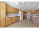 Spacious kitchen with ample wood cabinets, a white refrigerator, and tile flooring at 3023 W Quail Ave, Phoenix, AZ 85027