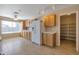 Bright kitchen featuring wooden cabinets, a large refrigerator, and a convenient walk-in pantry at 3023 W Quail Ave, Phoenix, AZ 85027