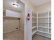 Convenient walk-in pantry with shelving provides ample storage, complemented by a separate laundry area at 3023 W Quail Ave, Phoenix, AZ 85027