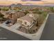 Scenic aerial view of a property with a circular design and mountain views in the distance at 31061 N 136Th Ln, Peoria, AZ 85383