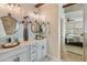 Beautiful bathroom with granite countertop, dual vessel sinks, stylish mirrors and light fixtures at 31061 N 136Th Ln, Peoria, AZ 85383