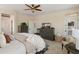 Main bedroom featuring a ceiling fan, tile floors, and shuttered windows at 31061 N 136Th Ln, Peoria, AZ 85383