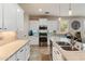 Modern kitchen with white cabinets, stainless steel appliances, and tile floors at 31061 N 136Th Ln, Peoria, AZ 85383