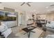 Bright living room with a ceiling fan, tile floors, and neutral colored walls at 31061 N 136Th Ln, Peoria, AZ 85383