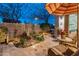 Serene patio with shaded seating and beautiful landscaping, perfect for relaxation at 31061 N 136Th Ln, Peoria, AZ 85383