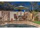 Relaxing poolside patio with dining set and umbrella, perfect for outdoor entertaining at 31061 N 136Th Ln, Peoria, AZ 85383