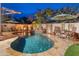 Sparkling pool with waterfall feature, seating areas, and beautiful landscaping at 31061 N 136Th Ln, Peoria, AZ 85383