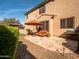 Back patio with seating, an umbrella, manicured landscaping, and a BBQ grill at 31816 N 19Th Ave, Phoenix, AZ 85085