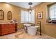 Relaxing bathroom featuring a freestanding tub, stone floors, and a stylish chandelier at 31816 N 19Th Ave, Phoenix, AZ 85085