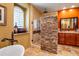 Luxurious bathroom with a stone accent wall, walk-in shower, and elegant vanity at 31816 N 19Th Ave, Phoenix, AZ 85085