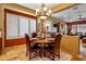 Cozy dining area featuring a round table, chandelier, and views into the living room at 31816 N 19Th Ave, Phoenix, AZ 85085