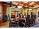 Elegant dining room with coffered ceiling, chandelier lighting, and rich wood furniture at 31816 N 19Th Ave, Phoenix, AZ 85085