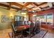 Dining area featuring coffered ceiling, chandelier lighting, and large windows overlooking the backyard at 31816 N 19Th Ave, Phoenix, AZ 85085