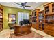 Well-appointed home office featuring custom built-in shelving, an elegant desk, and ample natural light for productivity at 31816 N 19Th Ave, Phoenix, AZ 85085