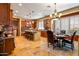 Gourmet kitchen with stainless steel appliances, a center island, and a chandelier-lit dining area at 31816 N 19Th Ave, Phoenix, AZ 85085