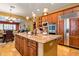 Beautiful kitchen island with granite countertops, wooden cabinetry, and pendant lighting at 31816 N 19Th Ave, Phoenix, AZ 85085