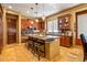 Modern kitchen with a large island, wooden cabinetry, pendant lighting, and stainless steel appliances at 31816 N 19Th Ave, Phoenix, AZ 85085