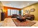 Inviting living room with plush seating, warm colors, plantation shutters, and elegant decor, perfect for relaxation at 31816 N 19Th Ave, Phoenix, AZ 85085