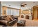 Relaxing living room with a comfortable sofa, an ottoman, and white window shutters at 31816 N 19Th Ave, Phoenix, AZ 85085