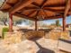 Gourmet outdoor kitchen featuring built-in grill, stone counters, and covered dining area at 31816 N 19Th Ave, Phoenix, AZ 85085