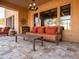 Comfortable outdoor seating area with plush cushions, stylish decor, and travertine tile flooring at 31816 N 19Th Ave, Phoenix, AZ 85085