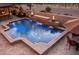 Inviting pool with travertine surround, fire bowls and cascading water feature at 31816 N 19Th Ave, Phoenix, AZ 85085