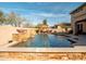 Resort-style pool with stone accents, overhead string lights, and desert landscaping at 31816 N 19Th Ave, Phoenix, AZ 85085