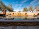 Luxury swimming pool with a stone waterfall feature and elegant travertine tile decking at 31816 N 19Th Ave, Phoenix, AZ 85085