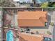 Aerial view of a house with a red tile roof, back yard with a pool, and desert landscaping at 3311 W Baylor Ln, Chandler, AZ 85226