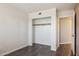 Bedroom features wood floors, white walls, open closet, and a door at 3311 W Baylor Ln, Chandler, AZ 85226