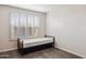 Bedroom with wood floors features a window with white shutters and a twin bed at 3311 W Baylor Ln, Chandler, AZ 85226