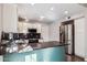 Modern kitchen with white cabinetry, stainless steel appliances, dark granite countertops, and a large island at 3311 W Baylor Ln, Chandler, AZ 85226