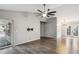 Open living room showcasing a ceiling fan, wood floors, a sliding glass door, and neutral paint at 3311 W Baylor Ln, Chandler, AZ 85226