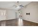 Open living room featuring wood floors, a ceiling fan, and sliding glass doors to the backyard at 3311 W Baylor Ln, Chandler, AZ 85226