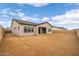 Backyard featuring stucco wall, covered patio, and dirt landscaping at 34283 N Sandpiper Trl, Queen Creek, AZ 85144