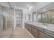 Bathroom featuring double vanities, modern fixtures, and a walk-in shower at 34283 N Sandpiper Trl, Queen Creek, AZ 85144