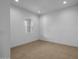 Empty bedroom featuring tile flooring, a single window, white walls, and recessed lighting at 34283 N Sandpiper Trl, Queen Creek, AZ 85144