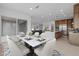 Dining area with a marble table, seating for six, and kitchen in the background at 34283 N Sandpiper Trl, Queen Creek, AZ 85144