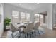 Modern dining room with table, six chairs, and sliding glass door to the patio at 34283 N Sandpiper Trl, Queen Creek, AZ 85144