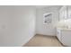 Laundry room featuring tile flooring, white walls, cabinets, and a window for natural light at 34283 N Sandpiper Trl, Queen Creek, AZ 85144