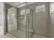 Walk-in shower with glass enclosure, modern fixtures, and tiled walls at 34283 N Sandpiper Trl, Queen Creek, AZ 85144