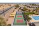 Aerial view of community pickleball courts, community pool, landscaping, parking and desert terrain at 3864 W Fairway Dr, Eloy, AZ 85131