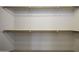 Spacious closet with wooden rods and white shelving for optimal organization at 3864 W Fairway Dr, Eloy, AZ 85131