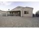 Rear elevation featuring covered patio, neutral stucco, and gravel landscaping at 3864 W Fairway Dr, Eloy, AZ 85131